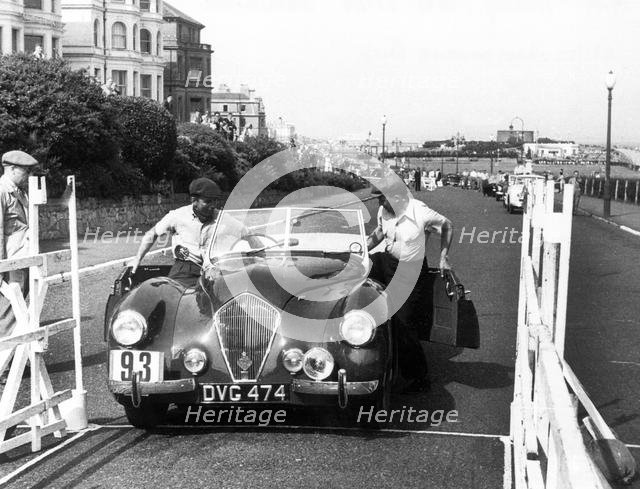 Healey Westland 2.4, Eastbourne Rally 1952, S.P.A. Freeman getting into car. Creator: Unknown.