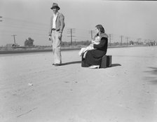 Young family, penniless, hitchhiking on U.S. Highway 99, California, 1936. Creator: Dorothea Lange.
