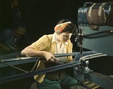A girl riveting machine operator at the Douglas Aircraft Company plant..., Long Beach, Calif. , 1942 Creator: Alfred T Palmer.