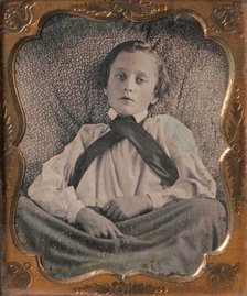 Boy Seated Cross-legged, Partially Covered by Blanket, Leaning Against Cushion, 1850s. Creator: Unknown.