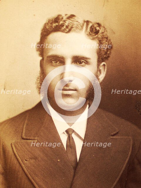 Studio portrait of unidentified man with long sideburns and wavy hair, c1870-c1879. Creator: Moses Parker Rice.