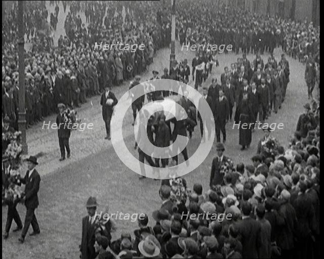 Huge Crowds Watching the Funeral Procession of Terence MacSwiney. His Coffin Is Draped..., 1920. Creator: British Pathe Ltd.