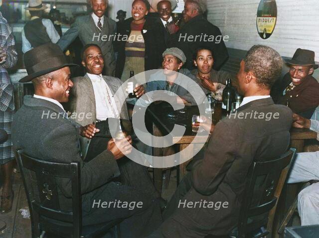 African Americans conversing and drinking beers in a bar, Clarksdale, Mississippi Delta, Nov 1939. Creators: Farm Security Administration, Marion Post Wolcott.
