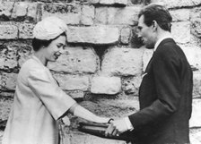 The Earl of Snowdon hands over the keys to Caernarvon Castle to Queen Elizabeth II, 1963. Artist: Unknown