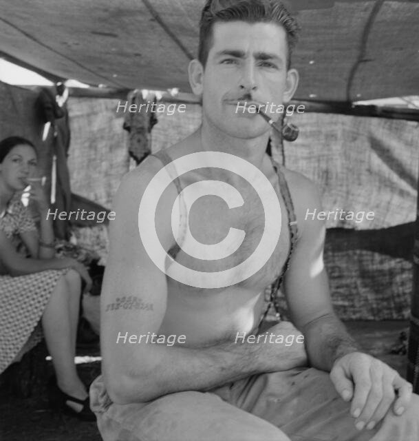 Unemployed lumber worker goes with his wife to the bean harvest, Oregon, 1939. Creator: Dorothea Lange.