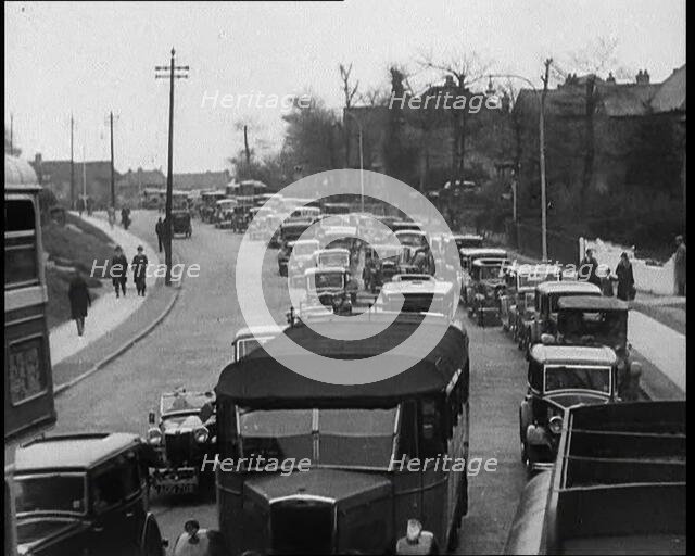Cars Driving Down a Road Towards the Camera, 1930s. Creator: British Pathe Ltd.