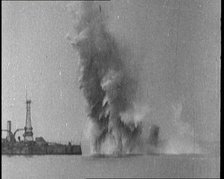 Bombs Dropped from Planes Exploding near a Warship, 1922. Creator: British Pathe Ltd.