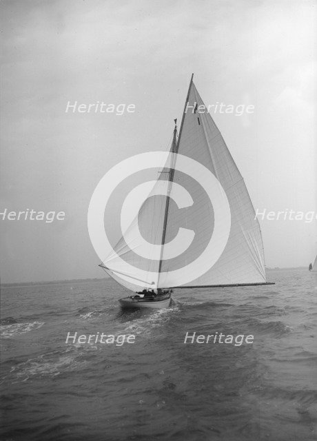 The 7 Metre 'Marsinah' (K1) sailing with spinnaker, 1912. Creator: Kirk & Sons of Cowes.