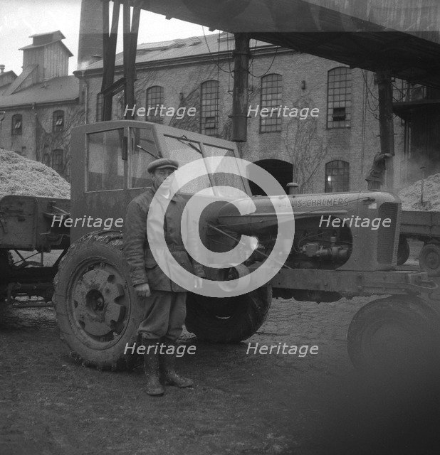 Man with a tractor at the sugar mill in Arlöv, Scania, Sweden, c1940s(?). Artist: Otto Ohm