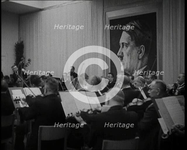 Orchestra Playing with a Portrait of Adolf Hitler in the Background, 1930s. Creator: British Pathe Ltd.