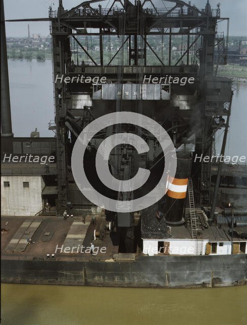 Loading coal into a lake freighter at the Pennsylvania Railroad docks, Sandusky, Ohio, 1943. Creator: Jack Delano.