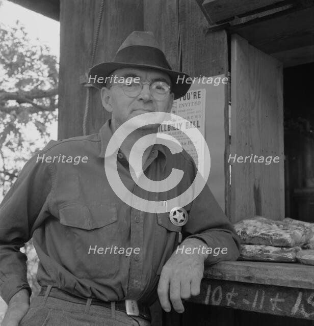 Deputy sheriff, stationed at paymaster's window..., near Grants Pass, Josephine County, Oregon, 1939 Creator: Dorothea Lange.