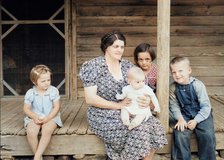 Wife and children of tobacco sharecropper on front porch, Person County, North Carolina, 1939. Creator: Dorothea Lange.