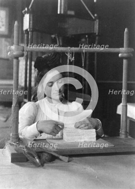 Woman doing bookbinding at Roycroft Shops, E. Aurora, N.Y., 1900. Creator: Frances Benjamin Johnston.