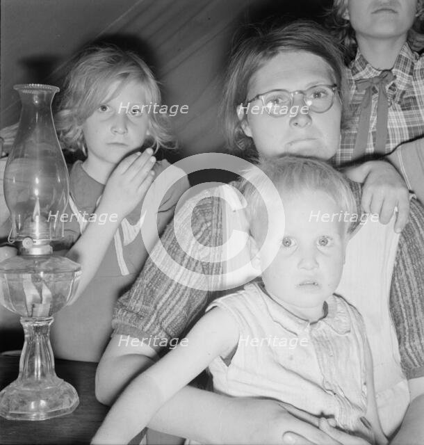 Family of six in tent after supper, FSA mobile unit, Merrill, Klamath County, Oregon, 1939. Creator: Dorothea Lange.