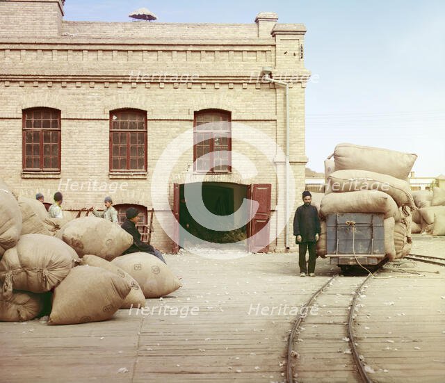 Labourers loading sacks onto railway at factory warehouse, between 1905 and 1915. Creator: Sergey Mikhaylovich Prokudin-Gorsky.