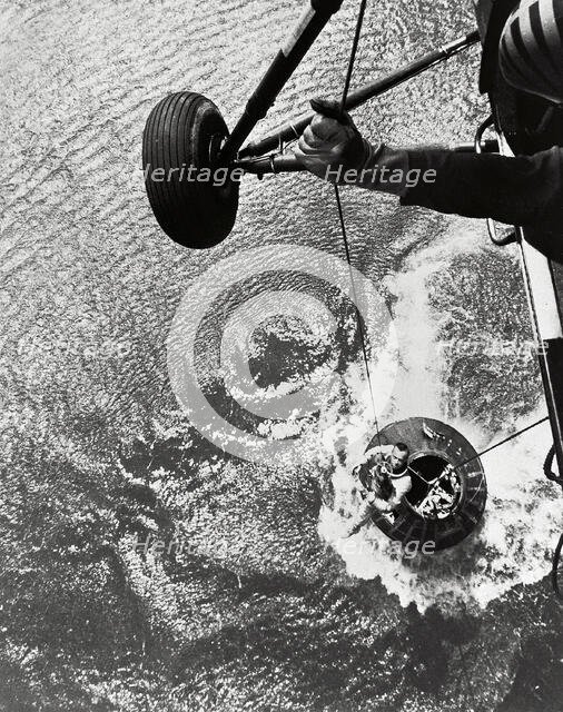 Shepard hoisted from Mercury capsule, 1961.  Creator: NASA.