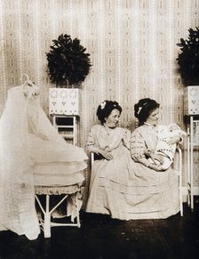 Josefa Blazek and Rosalia Blazek (Rosa Blazek), female conjoined twins, seated, holding...c1910. Creator: Unknown.