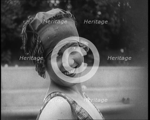 Young Female Civilian Wearing a Jaunty Swimming Hat Posing for the Camera, 1920. Creator: British Pathe Ltd.