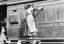 A woman cleaning railway carriages at Marylebone station, April 1915. Artist: Unknown
