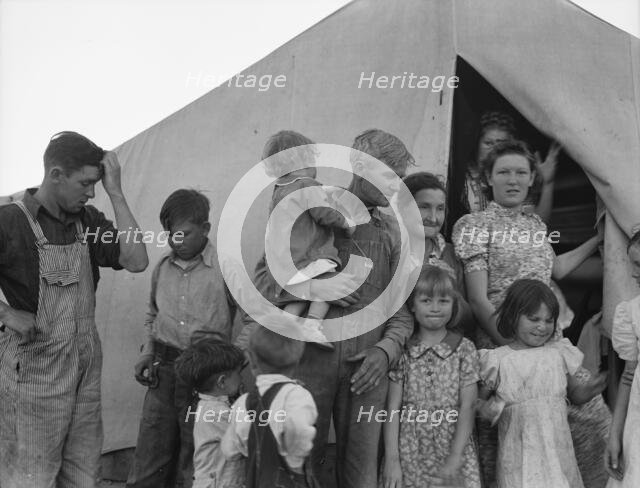 In FSA migrant labor camp during pea harvest, Brawley, Imperial County, California, 1939. Creator: Dorothea Lange.