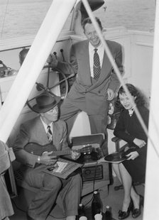 Portrait of Cliff Edwards, Betty Brewer, and Frank...Ukelele Lady (yacht), Hudson River, N.Y., 1947. Creator: William Paul Gottlieb.