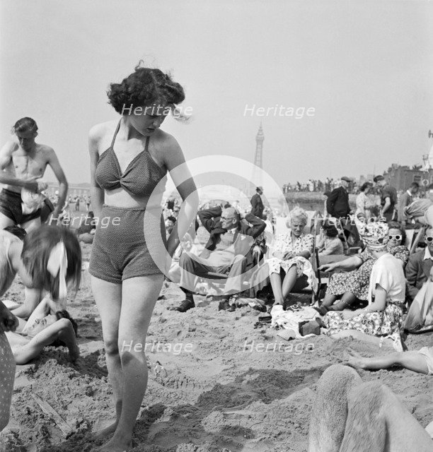 A young woman in a knitted bathing costume on the beach, Blackpool, c1946-1955. Artist: John Gay
