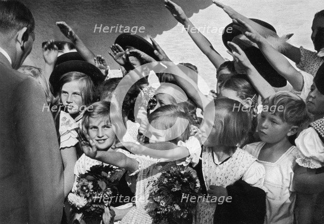 Adolf Hitler with a group of young children, 1936. Artist: Unknown