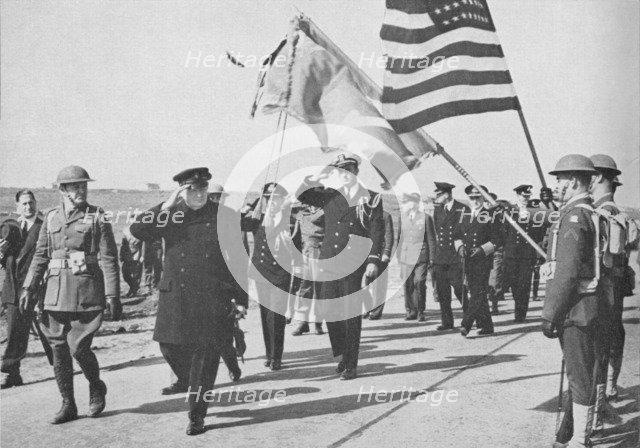 'Iceland visit. Churchill - with Ensign Franklin D. Roosevelt Jnr. following - saluting the Stars an