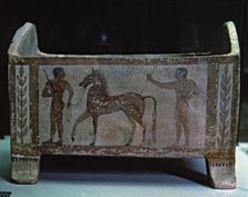 Etruscan funerary urn decorated with two men and a horse, preserved in the National Etruscan Muse…