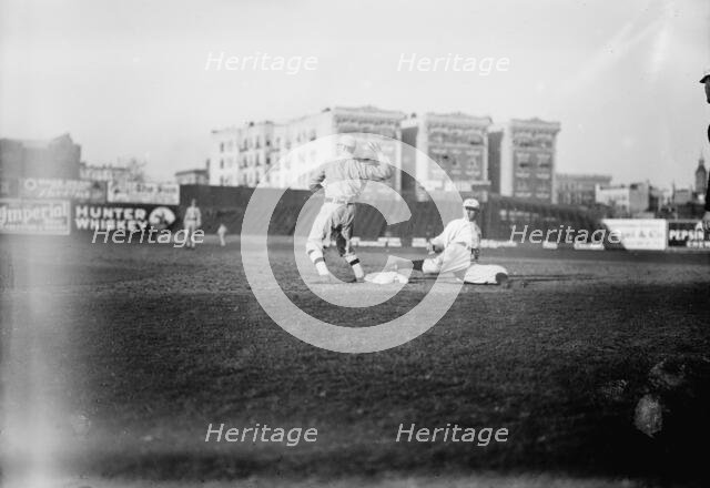 Guy Zinn, New York AL, sliding back into first base against Boston at Hilltop Park..., 1912. Creator: Bain News Service.