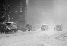 Horse-drawn wagons on snowy street, NY snow storm, 1910. Creator: Bain News Service.