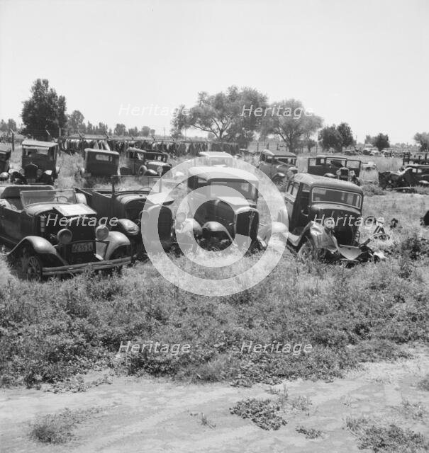 Used car lots and auto wrecking establishments, U.S. 99,  Near Tulare, California, 1939. Creator: Dorothea Lange.