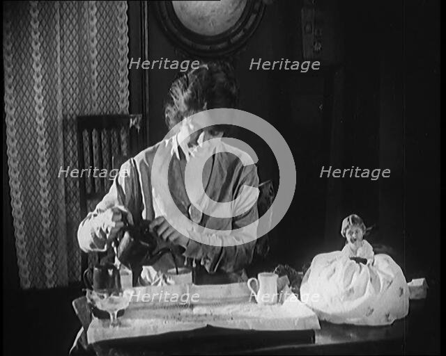 Female Civilian Seating at a Table Serving Tea, 1920. Creator: British Pathe Ltd.