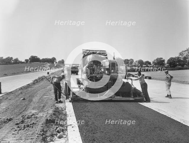 Laing workers operating a paver machine, London to Yorkshire Motorway (M1, 22/07/1959. Creator: John Laing plc.