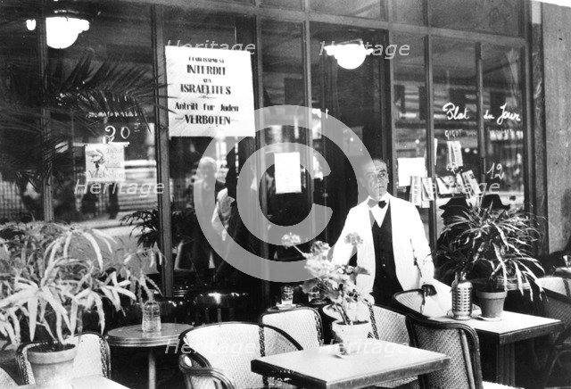 Notice in a restaurant window banning Jews from entering, German-occupied Paris, July 1940. Artist: Unknown