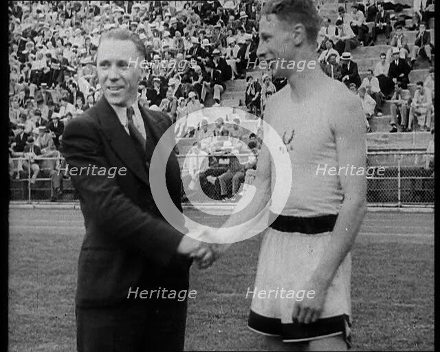 Jack Lovelock Shaking Hands With Someone as Crowds Watch, 1930s. Creator: British Pathe Ltd.