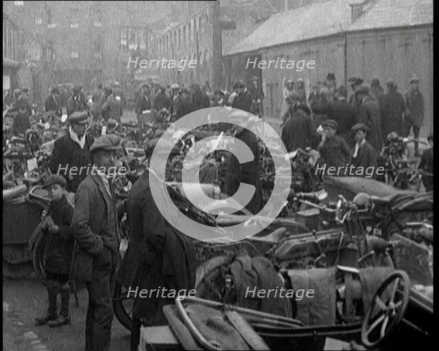 Men Standing Around Groups of Motorcars and Motorbikes, 1920. Creator: British Pathe Ltd.