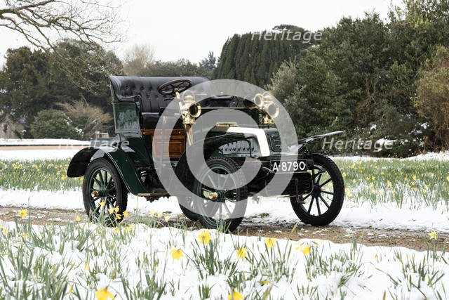 1904 De Dion Bouton model Q in snow with daffodils at Beaulieu. Creator: Unknown.