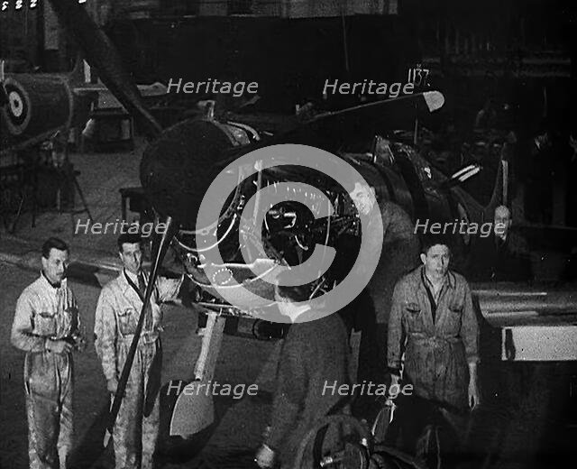 Factory Workers Inspecting a Spitfire Under Construction, 1940. Creator: British Pathe Ltd.