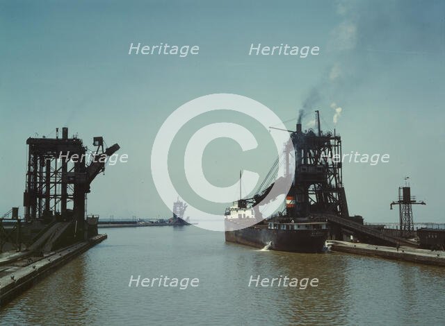 Loading a freighter with coal at one of the three coal docks owned by the..., Sandusky, Ohio, 1943. Creator: Jack Delano.