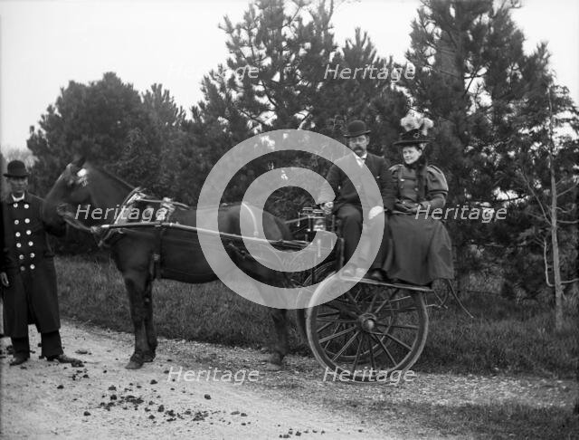 Unknown people in horse drawn cart and coachman; possibly Chester, England (Bache Hall), 1895. Creator: Robert Augustus Henry L'Estrange.