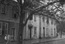 Facades of two-story houses, [Alexander Peronneau Tenements, 141 Church Street..., c1920-1926. Creator: Arnold Genthe.