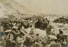 Japanese and Korean coolies removing supplies from wharf of Chemulpo, c1904. Creator: Robert Lee Dunn.