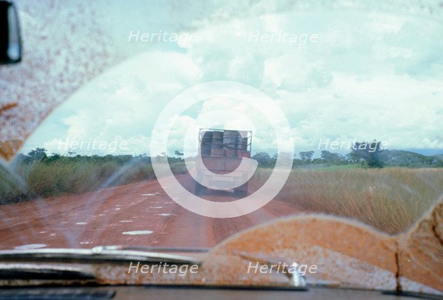 View through muddy windsreen on African dirt road. Artist: Unknown.