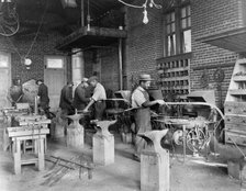 Young men training in blacksmithing at Hampton Institute, Hampton, Virginia, 1899 or 1900. Creator: Frances Benjamin Johnston.