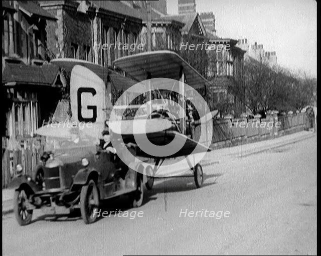 A Car Towing a Small Aeroplane With Its Wings Folded Over Along the Road, 1924. Creator: British Pathe Ltd.