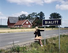 Girl by a road sign for Bialitt, Sweden. Artist: Torkel Lindeberg