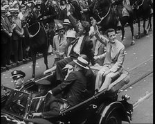 Wiley Post Sitting in a Car with Other Men, 1933. Creator: British Pathe Ltd.