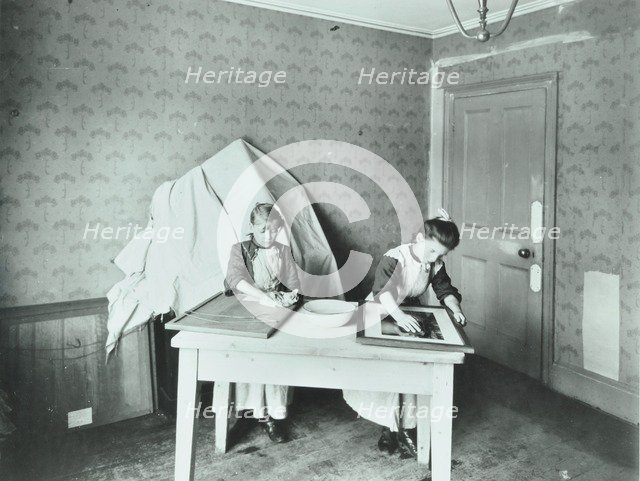 Spring cleaning; housewifery lesson, Denmark Hill School, Dulwich, London, 1908. Artist: Unknown.